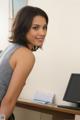 A woman sitting at a desk in front of a computer.