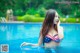 A woman in a bikini in a swimming pool.