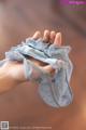 A close up of a person's hand holding a piece of cloth.